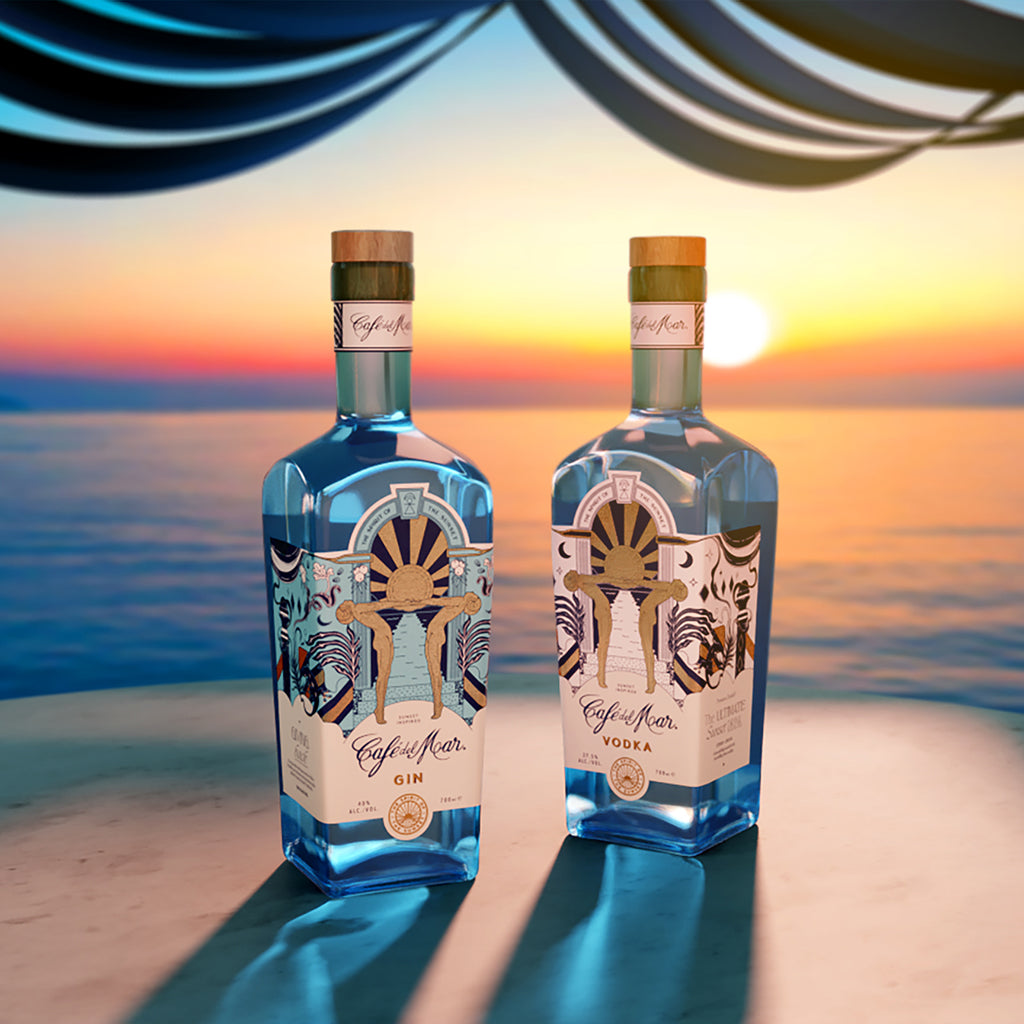 A bottle of Café del Mar Gin and Vodka on a table at sunset